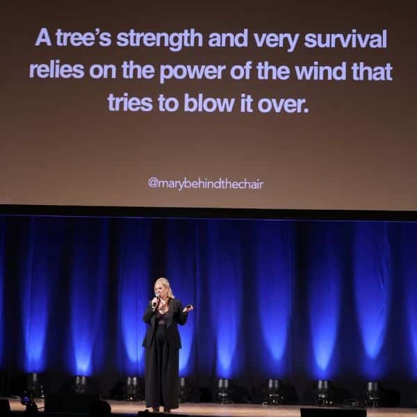 Mary Rector at the Orpheum Theatre in Los Angeles, California giving a motivational business presentation with tips on management, AI and social media for hairdressers.