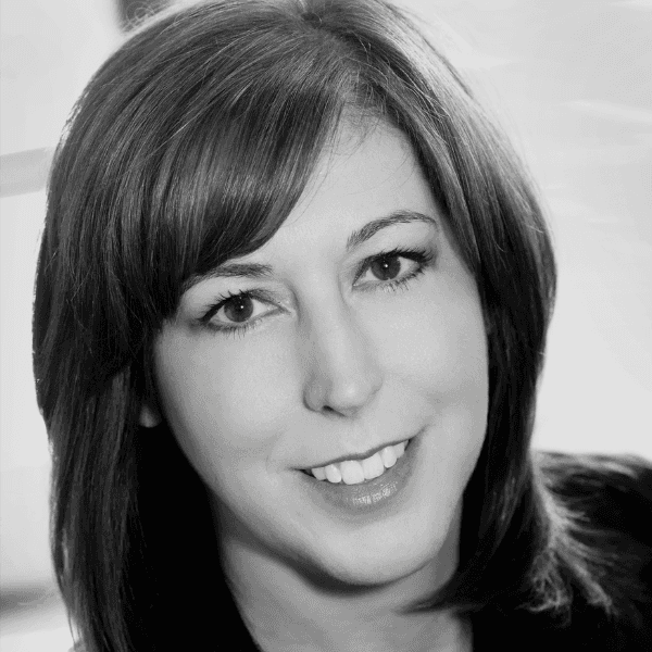 Black and white headshot of Andrea DeLeon, newly appointed General Manager of Kao Salon US, smiling with shoulder-length hair and professional attire.