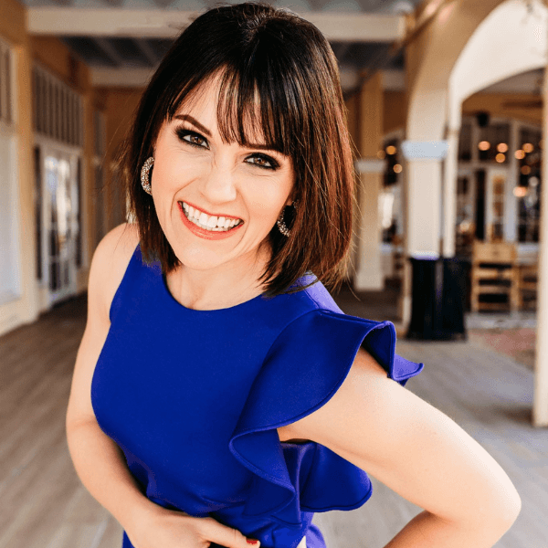 Leslie Perry, newly appointed Executive Director of the Professional Beauty Association, smiling in a vibrant blue dress.