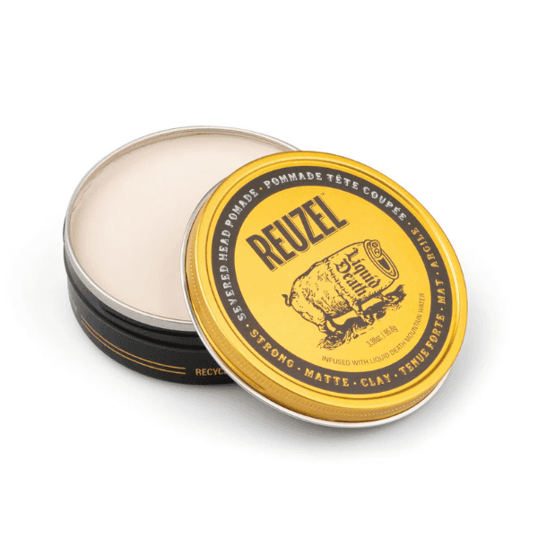 Reuzel x Liquid Death Severed Head Pomade on display in a yellow tin with brown writing.