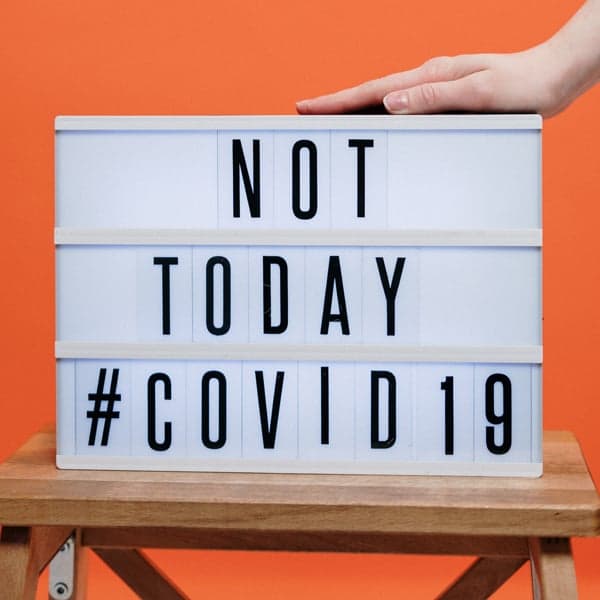 person-s-hand-on-a-covid19-sign-3952232