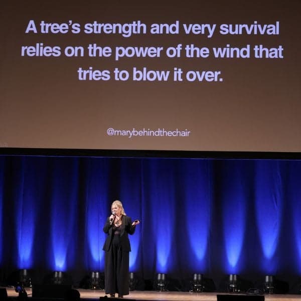 Mary Rector at the Orpheum Theatre in Los Angeles, California giving a motivational business presentation with tips on management, AI and social media for hairdressers.
