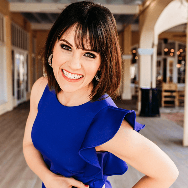 Leslie Perry, newly appointed Executive Director of the Professional Beauty Association, smiling in a vibrant blue dress.