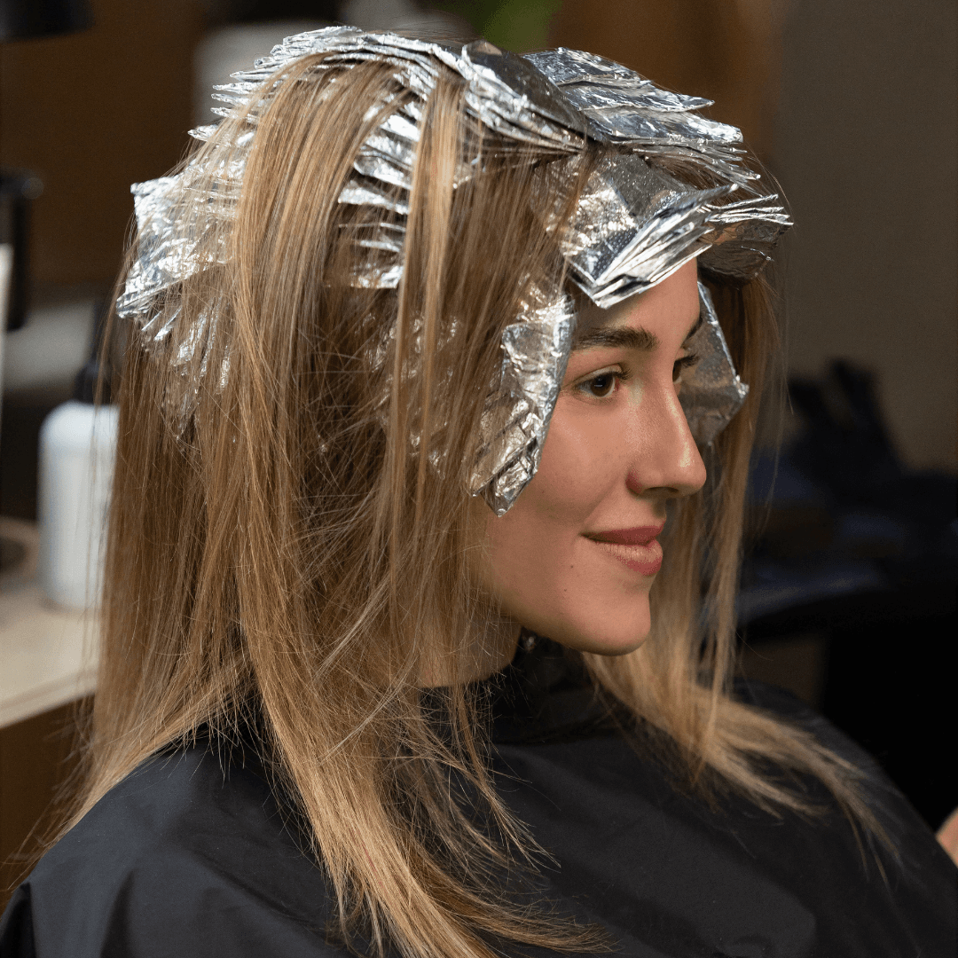 Foil highlights on light brown hair.