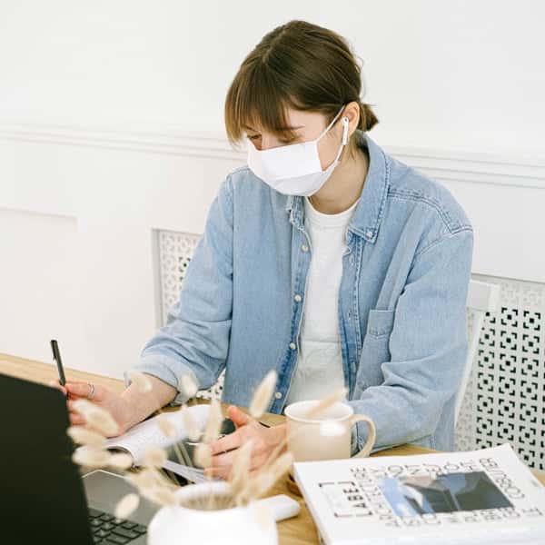 woman-in-face-mask-working-at-home-4240607