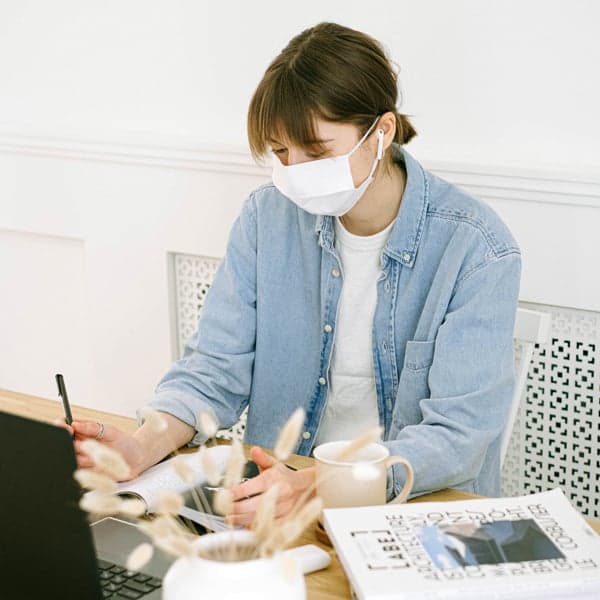 woman-in-face-mask-working-at-home-4240607