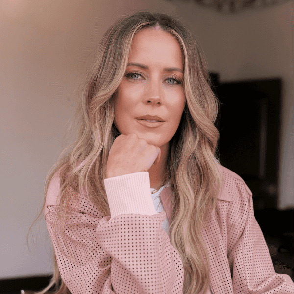 Headshot of Celebrity hairstylist Nikki Lee in a pink long sleeve shirt.