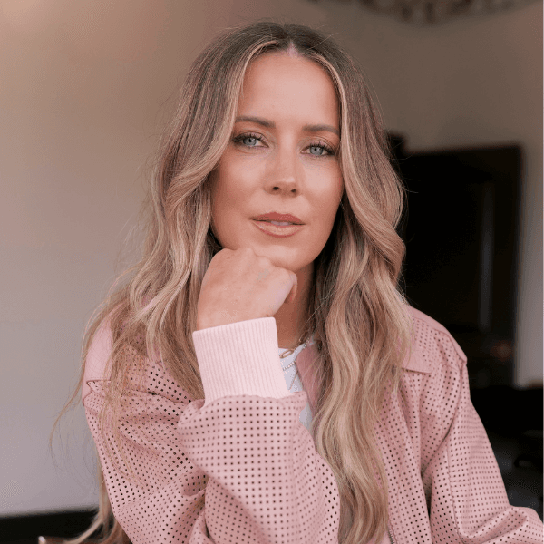 Headshot of Celebrity hairstylist Nikki Lee in a pink long sleeve shirt.