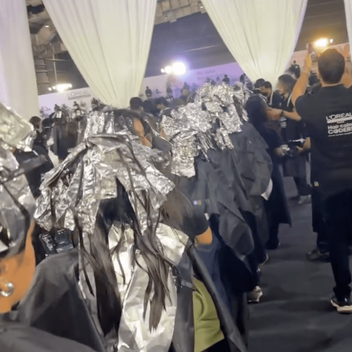 hundreds of models in line to rinse with foils