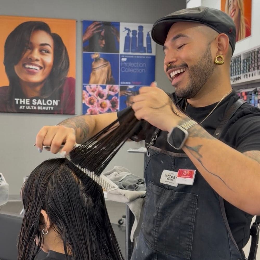 Stylist Leo Valencia performing a consultation and sectioning a client’s hair at the Ulta Beauty salon.
