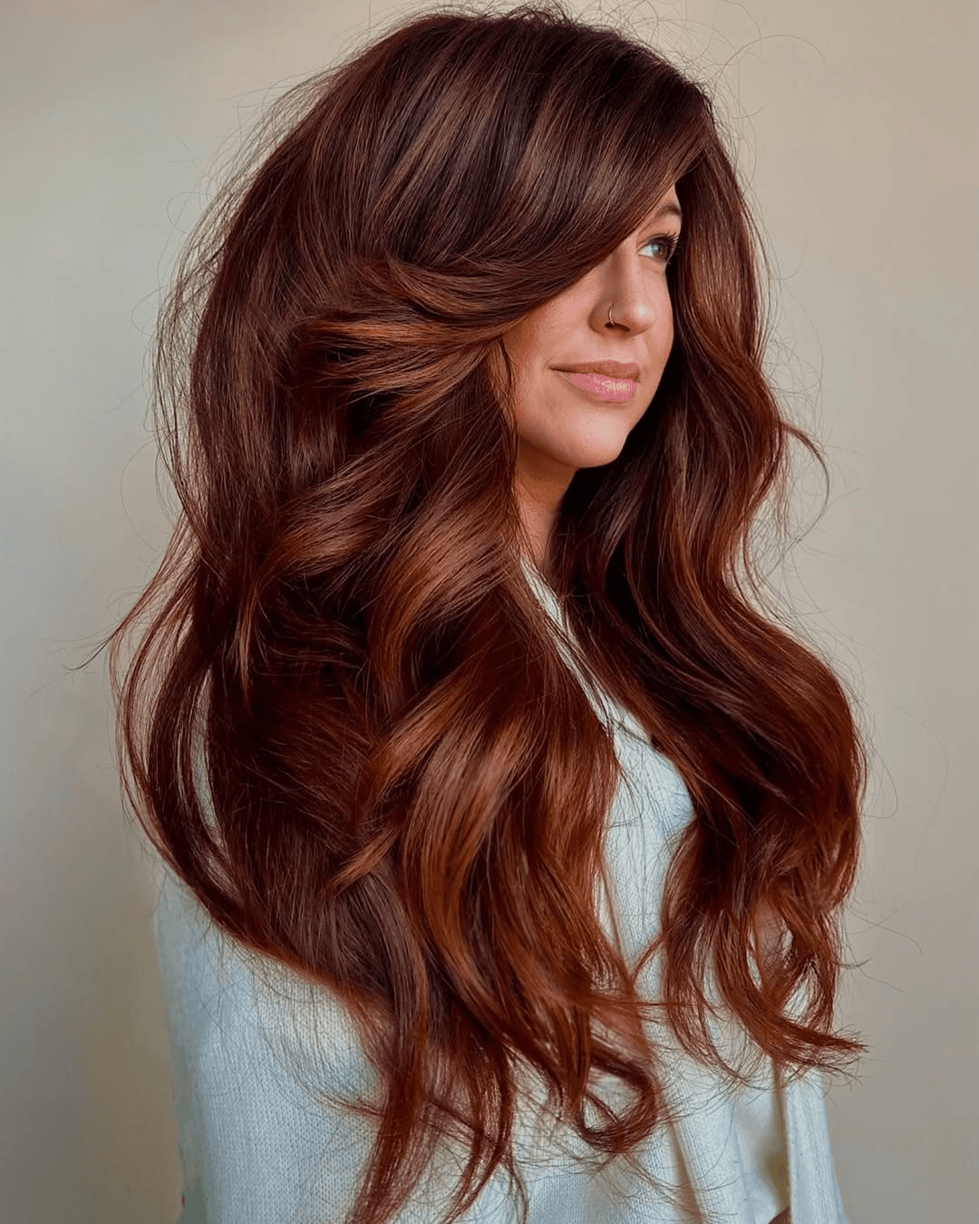 Long modern auburn hair with curtain fringe, soft layers and copper-red dimension