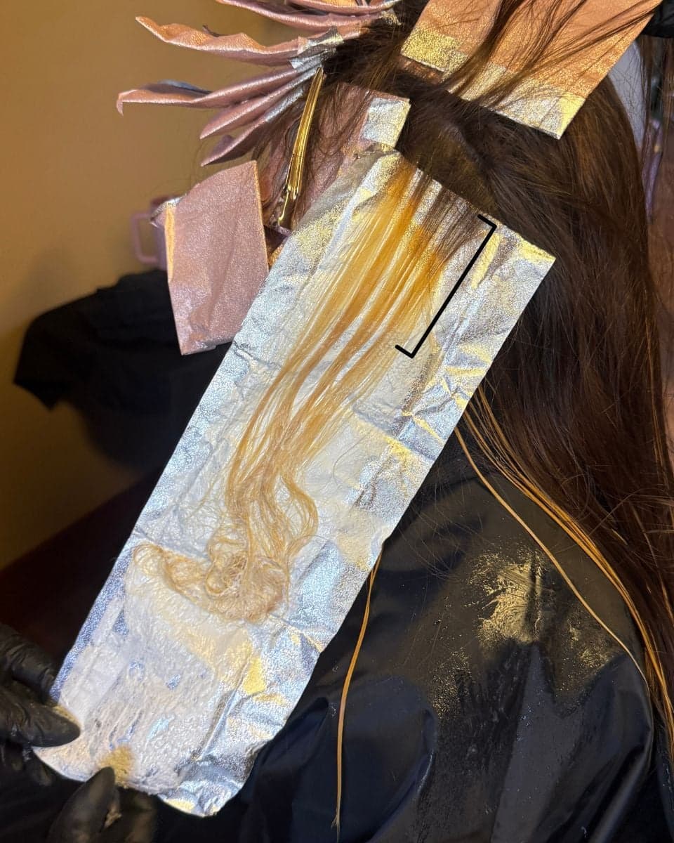 Close-up of a foil placement demonstrating Marina Sellecchia's balayage-inspired foil technique, featuring a softly feathered transition zone and fully saturated ends for seamless dimension.