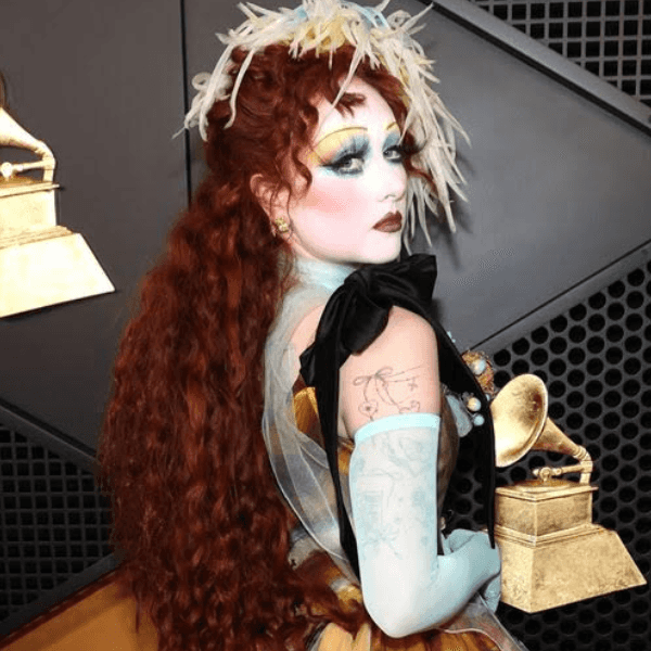 Chappell Roan’s voluminous textured waves and modern victory roll at the 2025 Grammys, styled by Dom Forletta using amika, Bellami and Wavytalk.