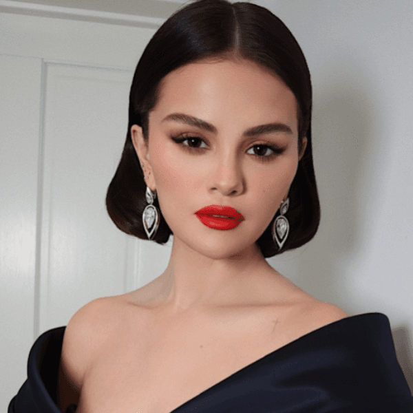 Selena Gomez stuns at the SAG Awards in a sleek bob with a middle part, paired with a black off-shoulder gown and statement earrings.