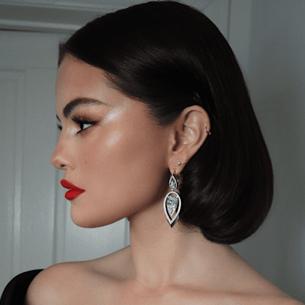 Close-up of Selena Gomez’s polished SAG Awards hairstyle—sleek, tucked bob with a deep middle part and glossy finish.