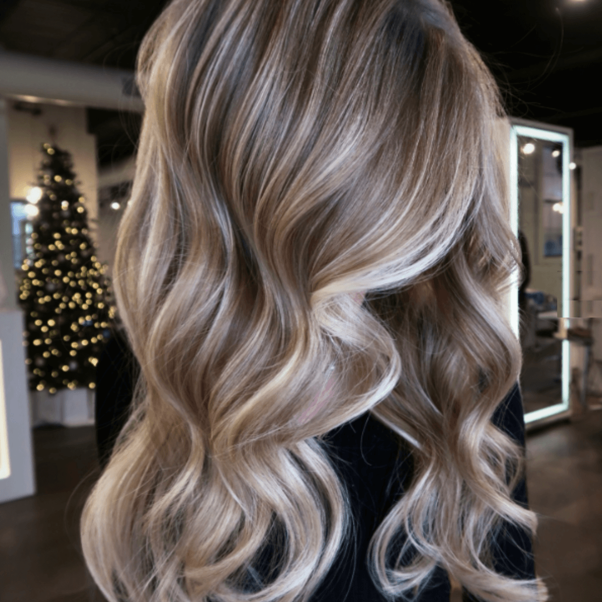 Soft dark bronde waves with a luminous, dimensional finish.