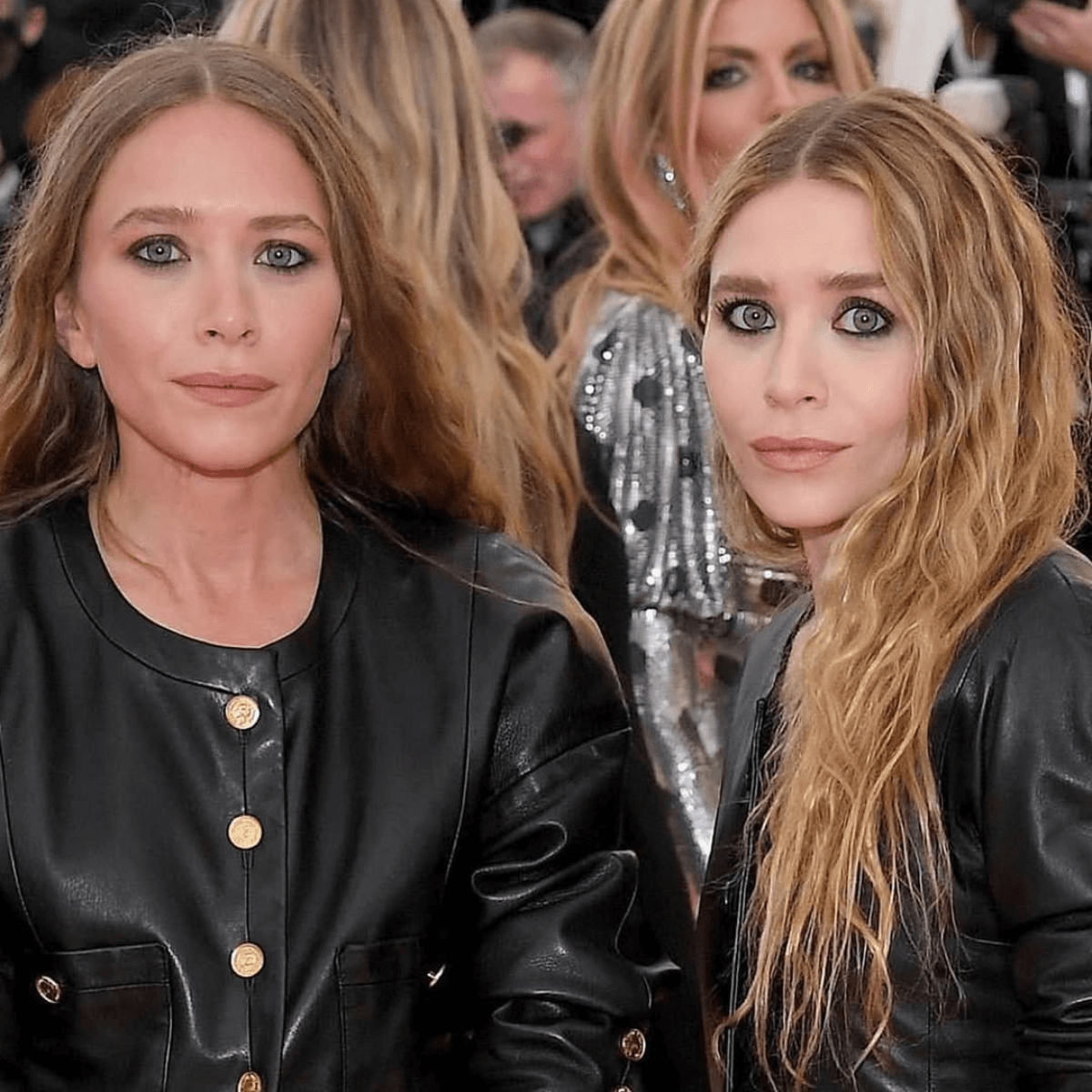 Olsen twins wearing soft waves and grown-out blonde—classic boho hair and early Olsen Dip vibes.