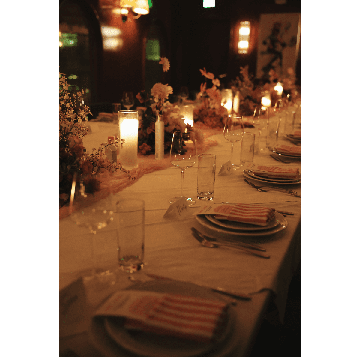 dinner table set with candles and low lighting