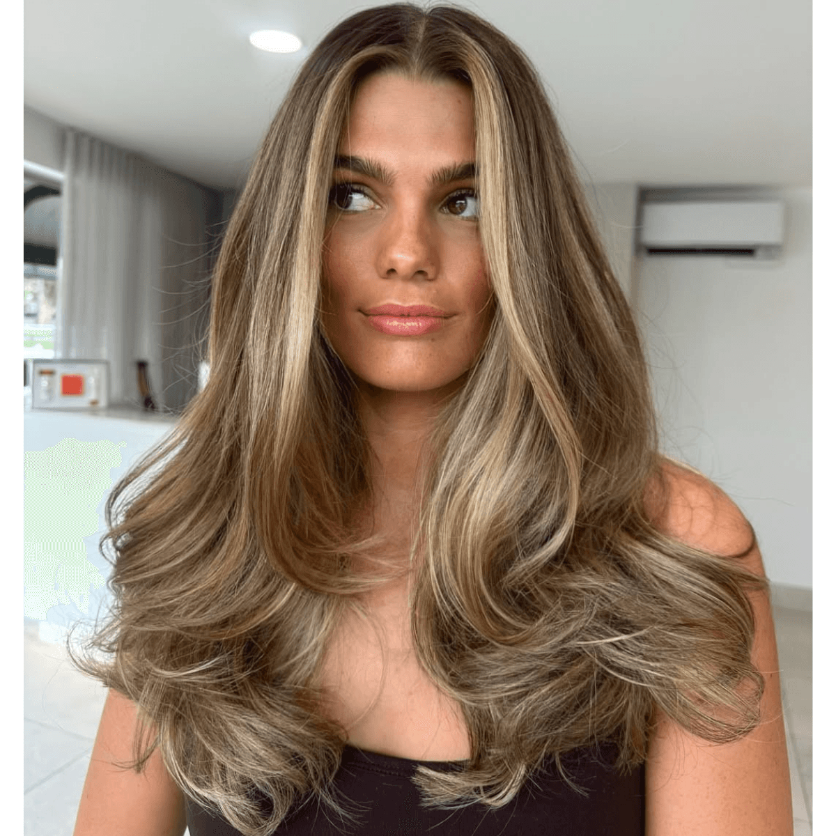 brown butter blonde hair with a bouncy blowout