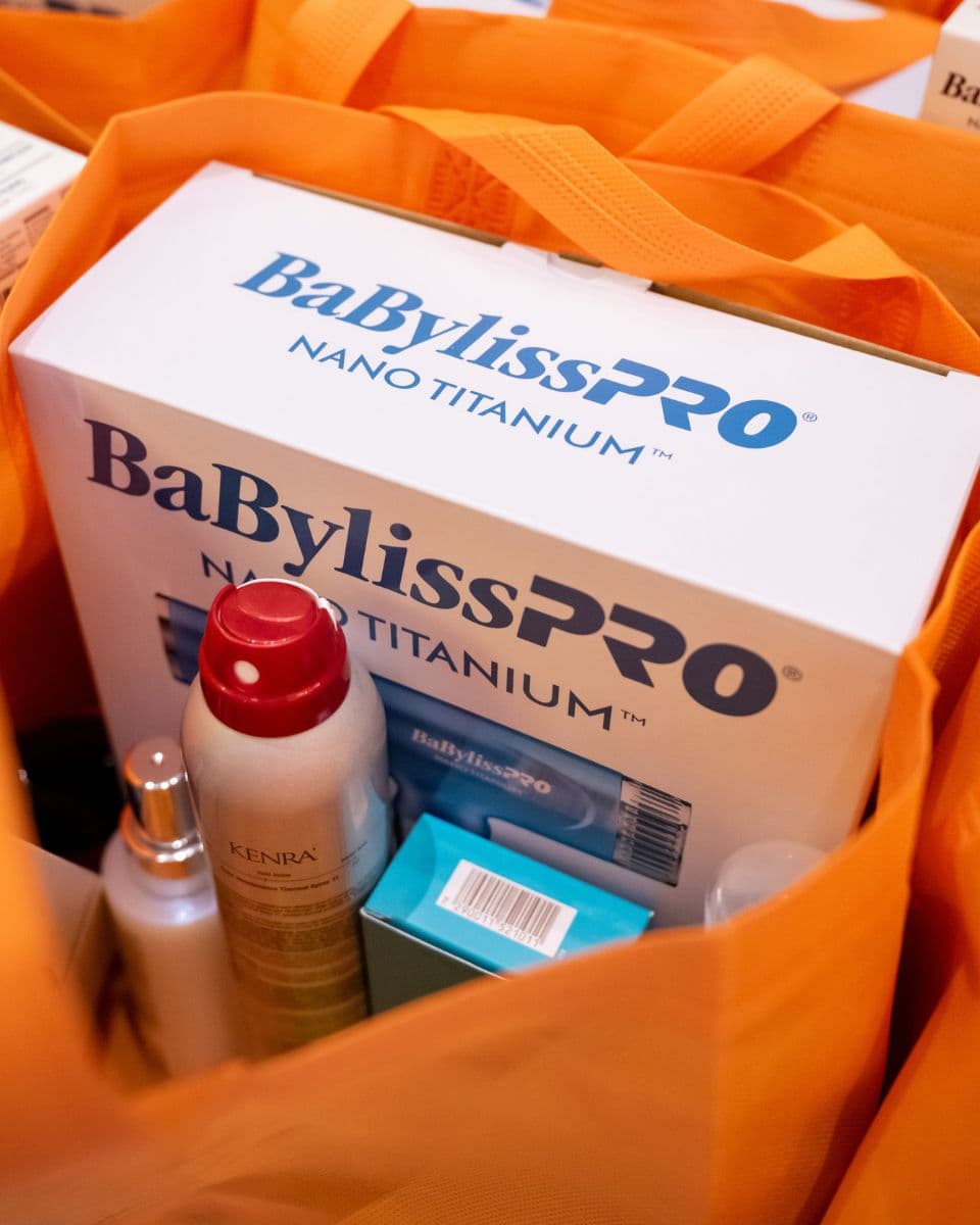Orange Ulta Beauty swag bag filled with BaBylissPRO, Kenra Professional and other professional beauty products.